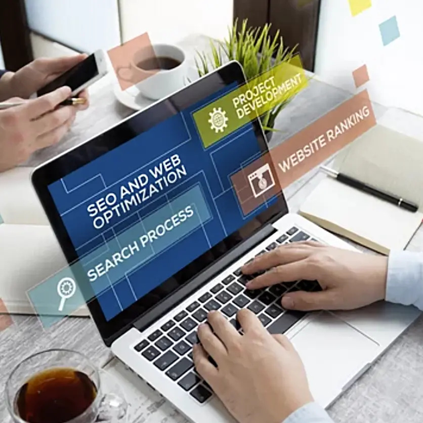 Image of a person coding SEO on a laptop